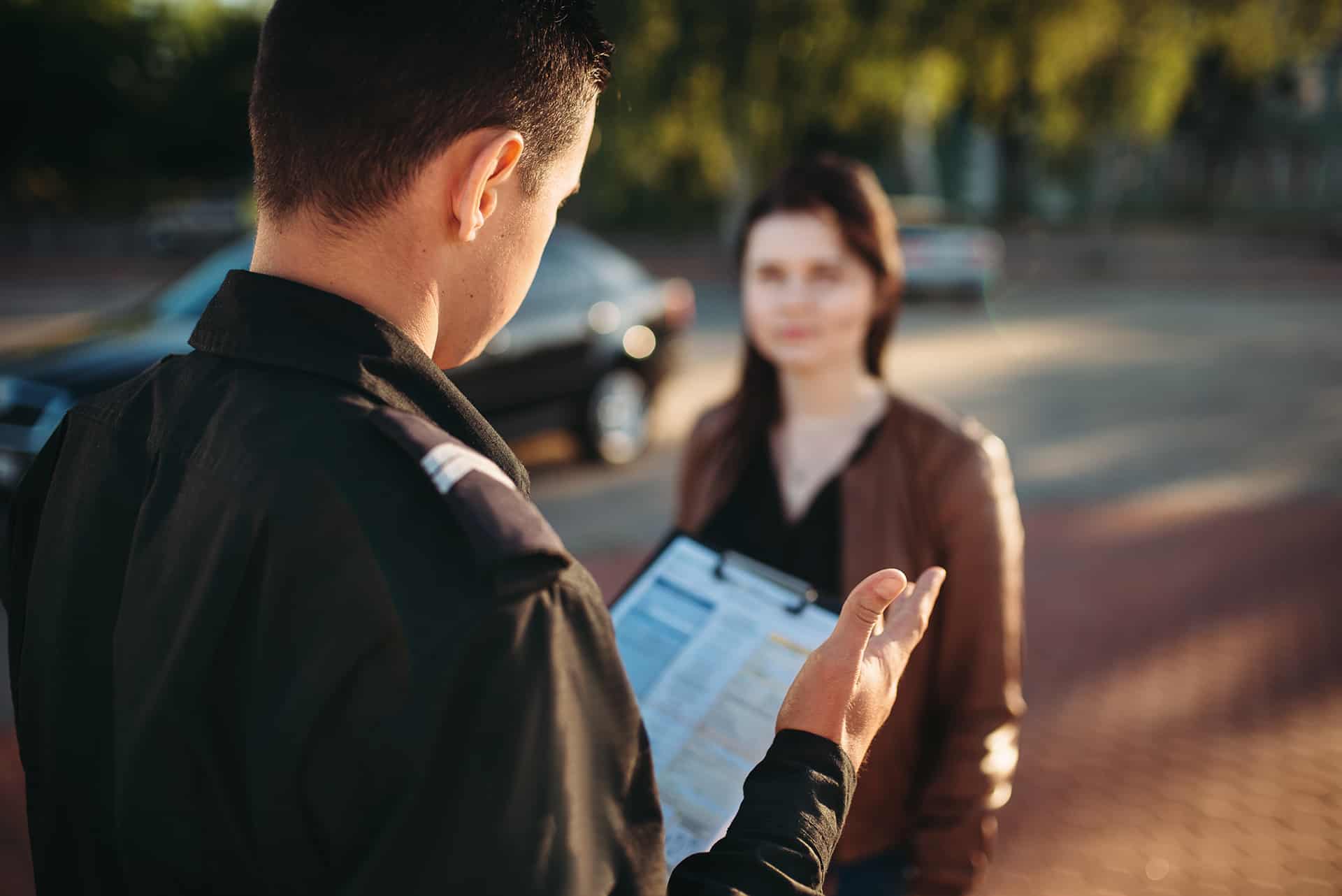 Police officer filing a report with a female